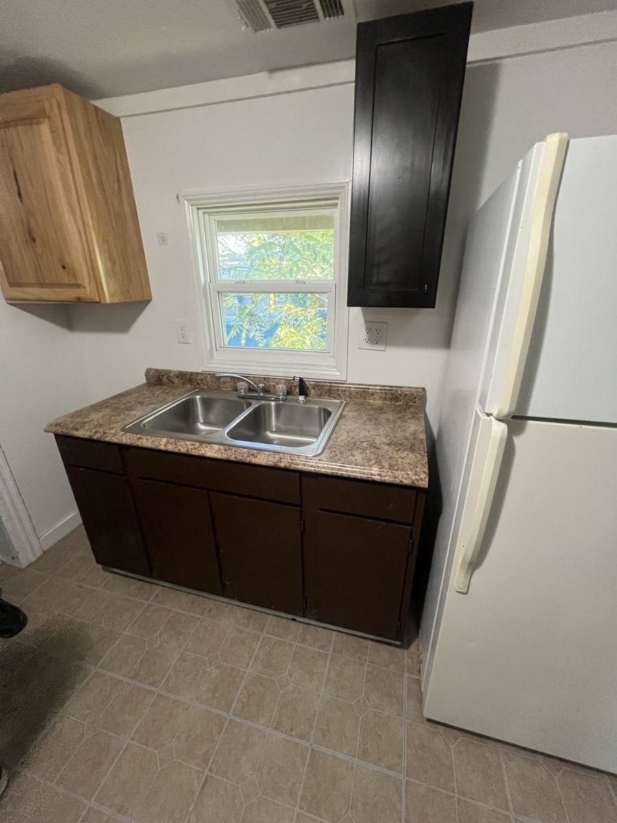 Kitchen with wood cabinets and a double sink
