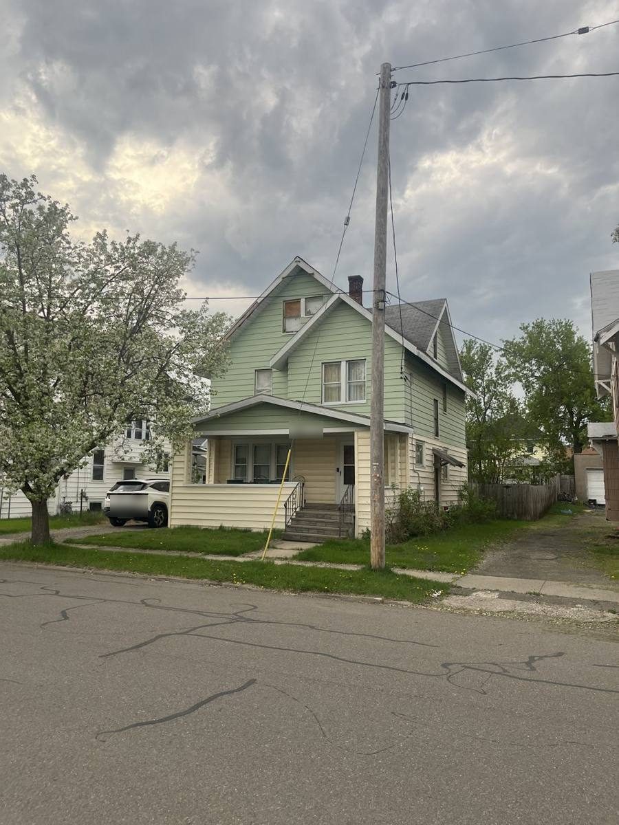 Two-story house with a front porch on a residential street in Endicott, NY
