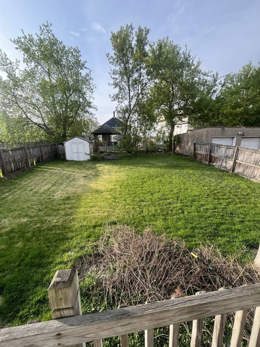 Fenced backyard with a small shed