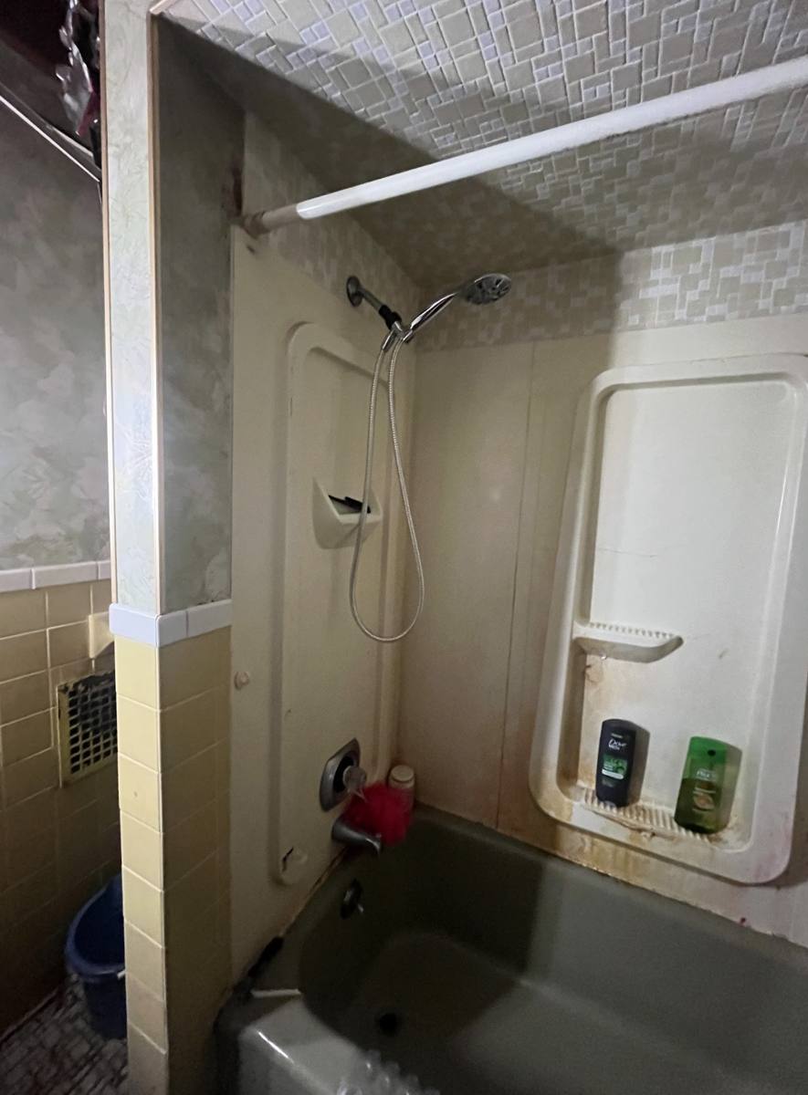 A bathroom in disrepair in a house we bought as-is